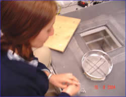 Graduate student Margarita Baquero performing calibration of 2D video disdrometer.